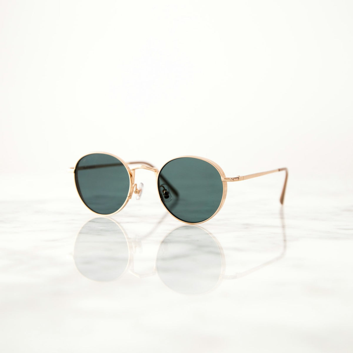 Aviator sunglasses held in hand