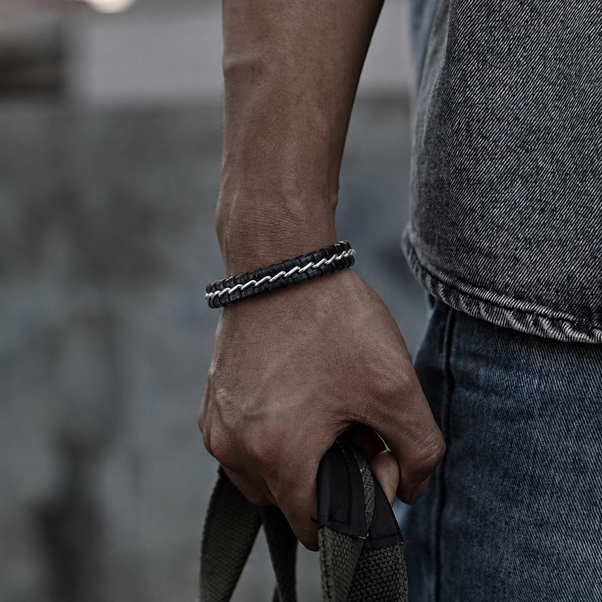 Black leather and steel chain bracelet on wrist